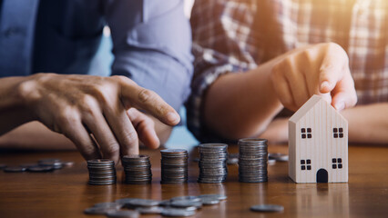 Save money and investment growth concept. Businessman hand holding coin on stack coins with white arrows rising. Financial and business, Management money for retire, tax, bank deposit, accounting.