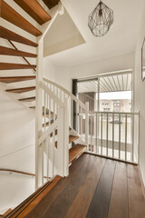the inside of a house with wood flooring and white railings on either side of the staircase leading up to the second floor