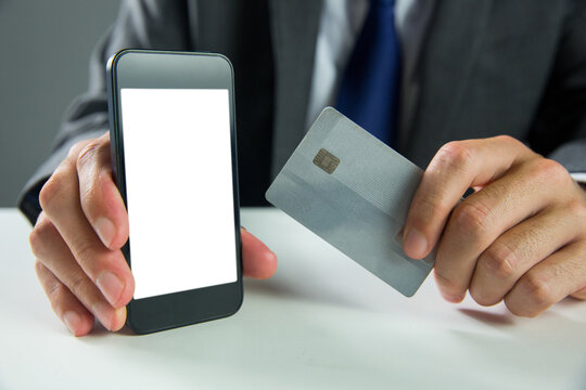 Digital png photo of man's hands holding smartphone and credit card on transparent background