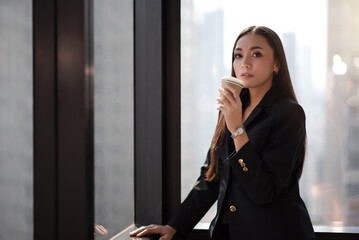 Confident Beautiful Asian Businesswoman Standing Against Office Background.