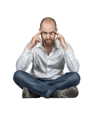 Thoughtful Caucasian man sitting cross-legged.