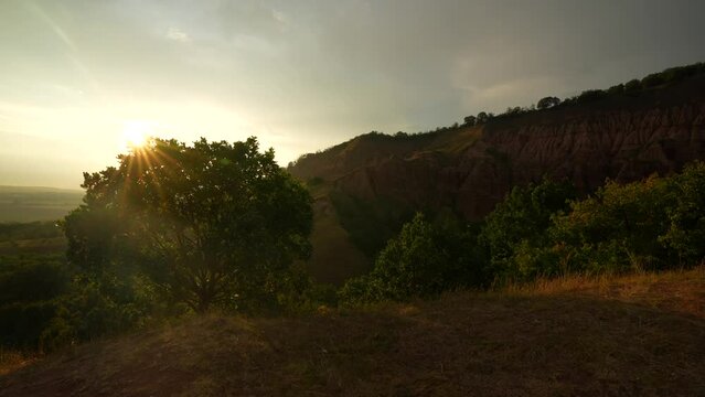 Beautiful 4k sunset video over this view to Red Ravine (Rapa Rosie in Romanian language) clay soil mountain shapes. Travel to Transylvania, Romania.