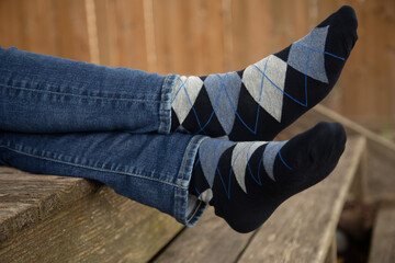 Outdoor product shots of men's blue argyle dress socks. 