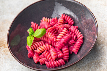 pink pasta beet sauce fusilli vegetable beetroot fresh food meal snack vegetarian food on the table...