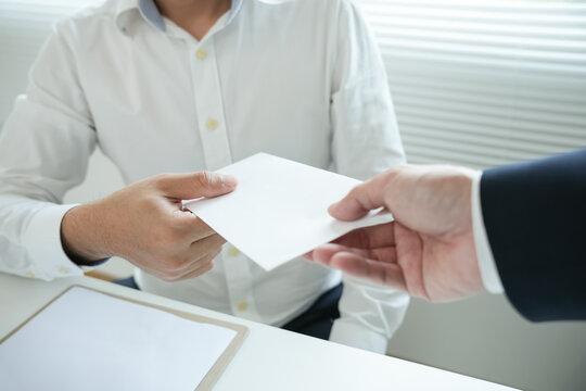 Businessmen receive salary or bonuses from management or Boss. Company give rewards to encourage work. Smiling businessman enjoying a reward at the desk in the office.