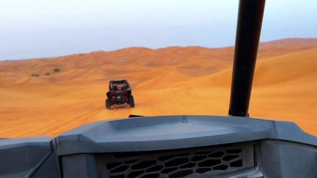 Riding buggies in the desert during sunset