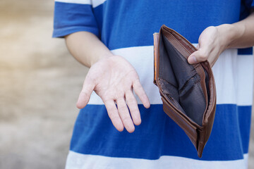 Close up hands holding empty wallet and bare hand . Concept, poor, bad economic crisis. Financial...
