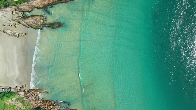 Sandy beach with rocks and turquoise sea. Aerial view