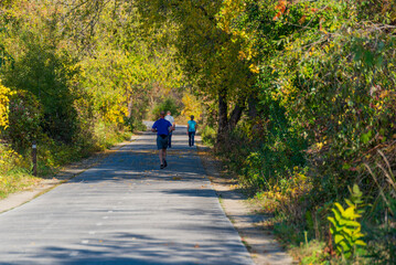 Obraz premium People Enjoying A Beautiful Fall Day On The Fox River Trail Near De Pere, Wisconsin