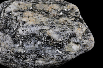 Piece of Granite Rock with Crystals Isolated Against a Black Background