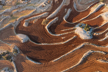 intricate patterns of a plowed field with terraces, harmoniously carved into the rolling hills, creating an awe-inspiring sight. Natural abstract background and textures