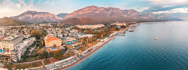 awe-inspiring aerial panorama of Kemer, Turkey, featuring luxurious hotels and majestic mountains in the backdrop.