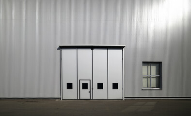 Big gray gates at industrial building for heavy machinery and engineering equipment concept