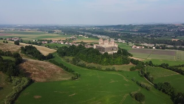 Aerial drone view of castle called Castello di Torrechiara, Parma, Emilia-Romagna, Italy. Bird eye view of Italian castle with towers and Medieval and Renaissance architecture features on green hill