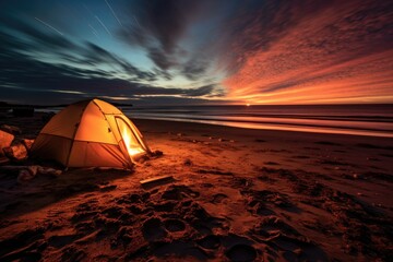 tent pitched on a sandy beach with a campfire
