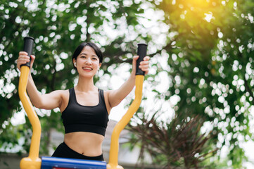 Young asian athletic sportswoman 30s wearing sportswear listening relaxing music while working out exercise equipment outdoor in park. Healthy lifestyle concept