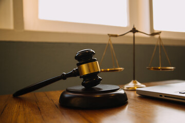Justice and law concept.Male judge in a courtroom with the gavel, working with, computer and...