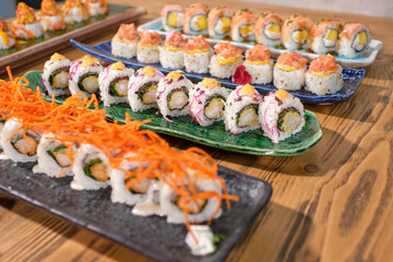 Set of delicious sushi rolls on marble plates