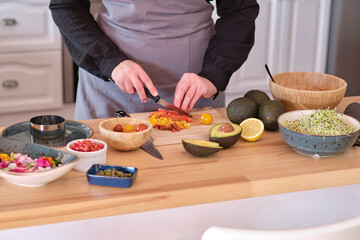 Obraz na płótnie Canvas Crop cook preparing tartar at table
