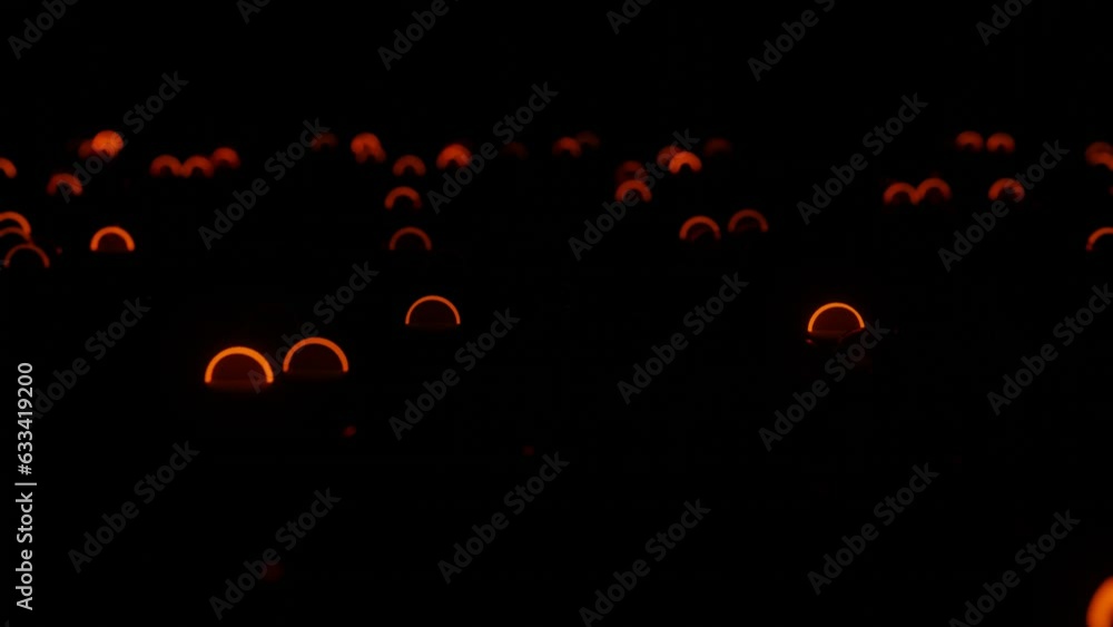Poster rows of different rings flashing in red-orange on a black background. looped animation. 3d render