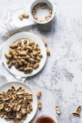 Top view of shelled groundnut in a plate, flatlay of shelled peanut in a plate on a marble countertop, nigerian roasted groundnut in a bowl