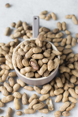 shelled groundnut in a small bowl, top view of shelled peanut in a bowl on a marble countertop, nigerian roasted groundnut in a bowl