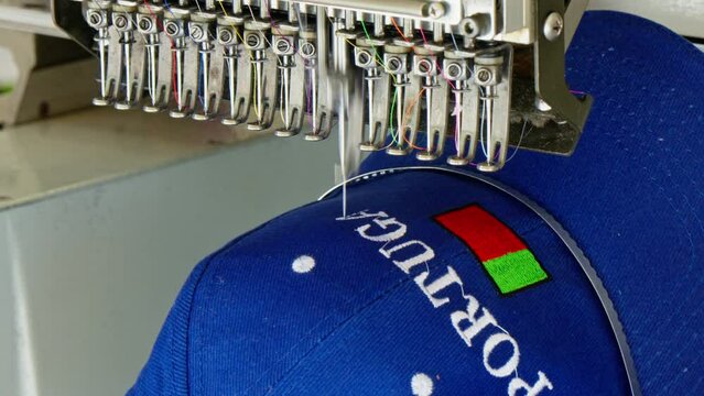 The machine makes embroidery on the cap