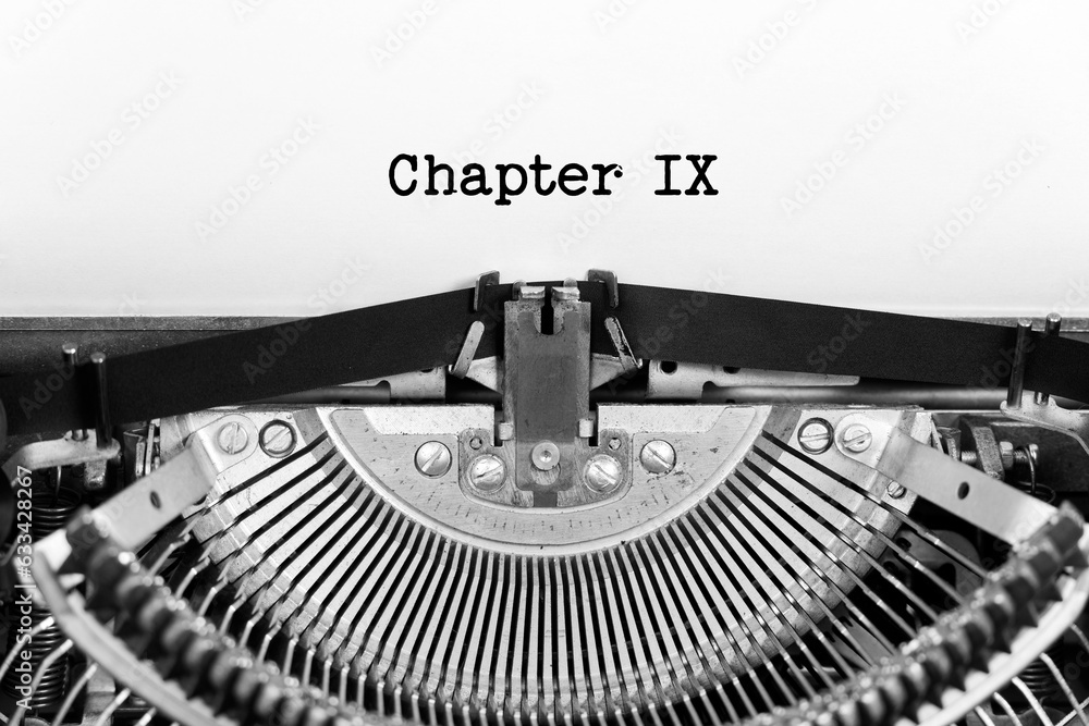 Poster chapter nine phrase closeup being typing and centered on a sheet of paper on old vintage typewriter 