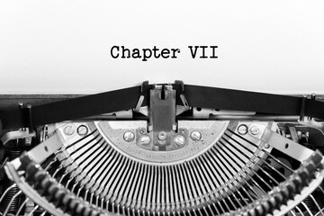 Chapter Seven phrase closeup being typing and centered on a sheet of paper on old vintage typewriter mechanical