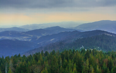 View to the south east from the tower on the Gorc mountain in Gorce (Poland) on a cloudy April day. In the distance Lubań (on the right)