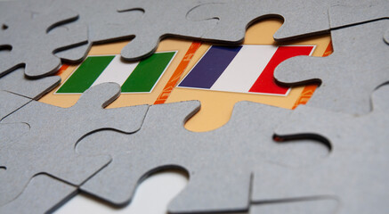 French and Nigeria flags surrounded with puzzles.