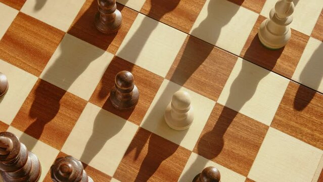 In chess, en passant the capture by a black pawn of an white enemy pawn, stop motion. Capturing a piece on the aisle in a chess game