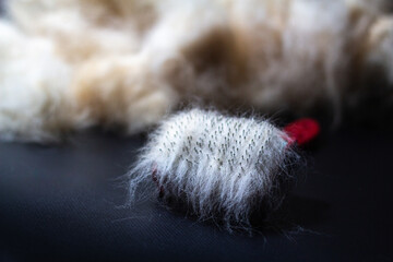 light wool on a comb on a dark background
