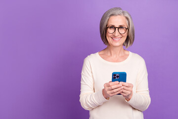 Photo of optimistic middle age lady using her samsung galaxy s20 smartphone check email google app...