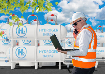 Hydrogen energy. Man engineer with laptop. Guy near hydrogen factory. Man employee of energy...
