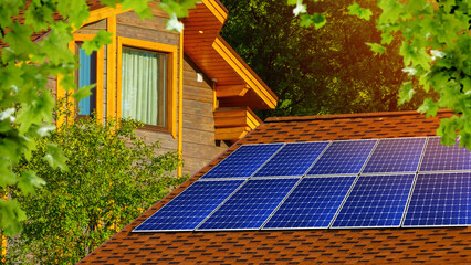 Solar panels on roof. Energy efficient house. Photovoltaic generators. Mansion with mini power plant. Roof of village house. Solar panels for generating electricity. Wooden cottage with solar panels