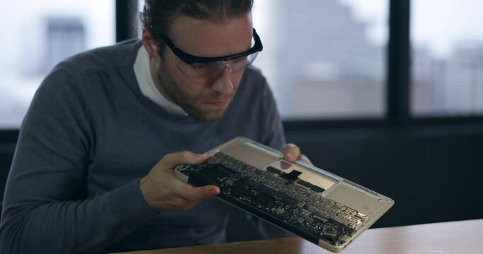 Repair, technology and technician working on circuit board in a workshop fixing motherboard or device for maintenance. Database, engineer and man employee or programer check a electrical hardware