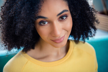 Close up photo of good mood satisfied pleasant woman with perming coiffure wear yellow long sleeve smiling to you at home room indoors