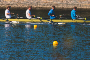 Group of rowing team athletes sculling during competition, kayak boats race in a rowing canal,...