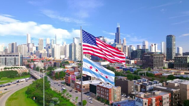 Aerial shot of Chicago downtown above the highway with American flag.