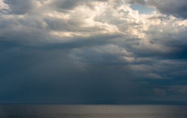 Seascape dramatic stormy clouds. Strom in the horizon. Rainy winter day in the ocean