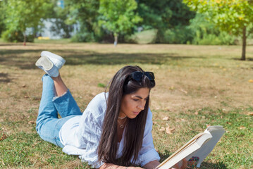 Woman reading a book in the summer park