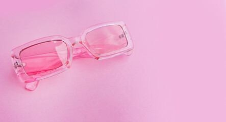 Pink sunglasses on a pink background 