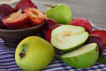 pears and plums on a towel