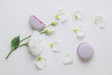 Beautiful Set colorful French macaroons and flowers. Flat lay, top view, spring white background. Concept celebration gift