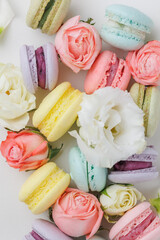 Beautiful Set colorful French macaroons and flowers. Flat lay, top view, spring white background. Concept celebration gift