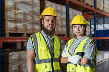 Portrait of male and female warehouse worker working at work scanning barcode on products boxes for checks stock, inventory with tablet on shelf pallet in the storage warehouse