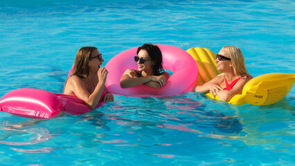 Closeup happy young women floating with air lilobal at pool party - Having fun on summer vacation - Travel, friendship, youth and tropical concep