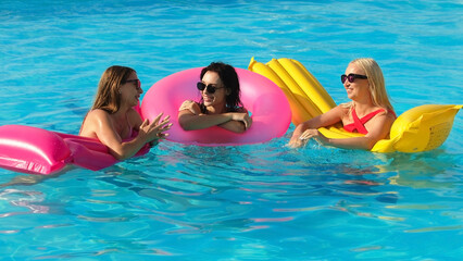 Closeup happy young women floating with air lilobal at pool party - Having fun on summer vacation - Travel, friendship, youth and tropical concep