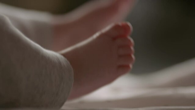 Moving baby's feet. Happy baby.